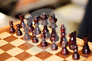 Chess set black side natural wood with focus on king and queen photo