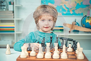 Chess strategy. Kid playing chess. Child and childhood. Clever concentrated and thinking child while playing chess.