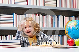 Chess, success and winning. Happy child playing chess. Child boy developing chess strategy, playing board game.