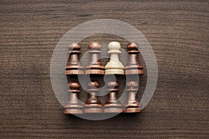 Chess uniqueness concept on wooden background