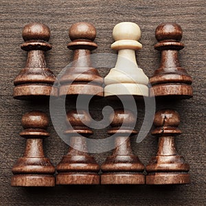 Chess uniqueness concept on wooden background