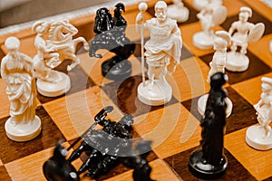 Chess white and black pieces fight on battlefield for their king