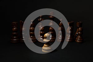 Chess. White pawn and Black figures on black background. Set of black figures.