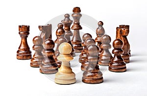 Chess. White pawn and Black figures on white background.