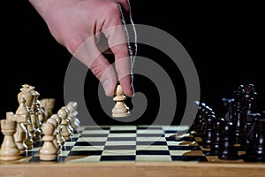 Chess. White pawn in the hands of a man