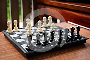 Chess white pawn invade attack black pawn. photo