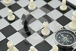 chessboard with a chess piece on the back Negotiating in business and compass. as background business concept and strategy