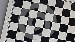 chessboard with combination of white and black wooden chess figures . Top view. High quality footage