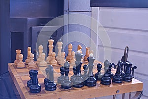 Chessboard with figures in front of the fireplace