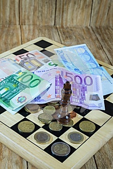 A chessboard, figures and money