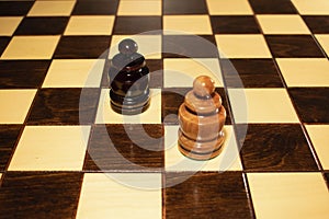 A chessboard with two opposing pawns