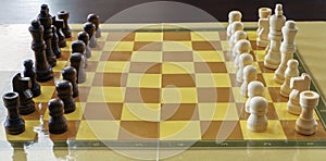 Chessboard with white and brown wooden chess pieces