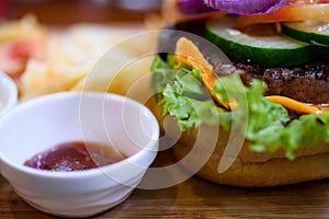 Chesse burger with vegetables and chips