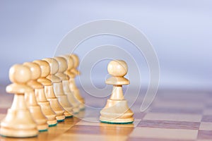 Chesspawns on the left are guided by the major pawn on the right