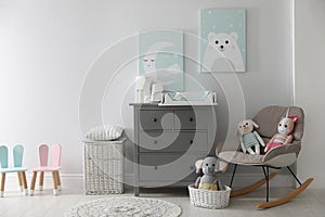 Chest of drawers with changing tray and pad in baby room. Interior design