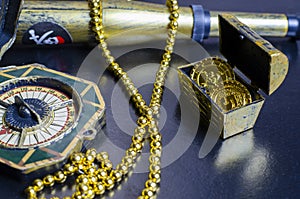 Chest with gold coins, a pirate necklace on a black background