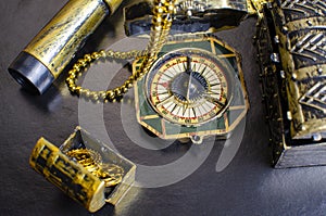 Chest with gold coins, a pirate necklace on a black background