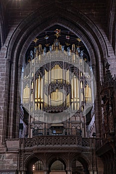 Close-up view of the church organ and pipes in the central nave of the historic Chester Cathedral in Cheshire