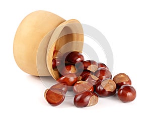 Chestnut in a wooden bowl isolated on white background closeup