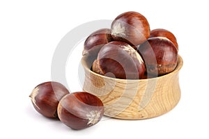 Chestnut in a wooden bowl isolated on white background. Top view photo