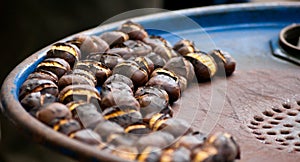 Chestnuts roasted on a blue barrel