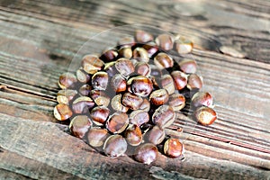 Chestnuts on wooden table outdoors