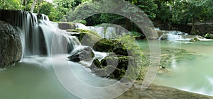 Chet Sao Noi Waterfall in tropical rainforest with rock and turquoise blue pond has 7 tiers. Namtok chet saonoi National Park