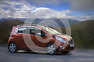 Chevrolet Spark orange car.