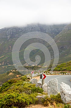 Chevron warning road sign for sharp hairpin bend on mountain pass