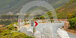 Chevron warning road sign for sharp hairpin bend on mountain pass