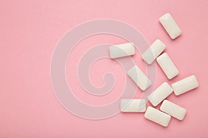 Chewing gum pieces on pink background. Space for text