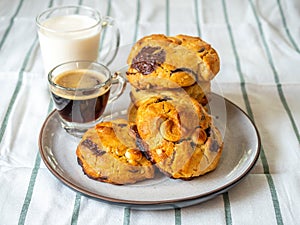 Chewy chocolate chip soft cookies with cup of coffee and milk