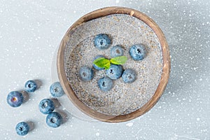 Chia pudding with blueberries in a coconut bowl