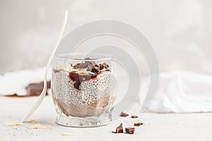 Chia pudding with chocolate, almonds and berry jam, copy space.