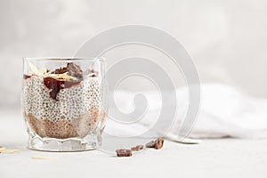 Chia pudding with chocolate, almonds and berry jam, copy space.