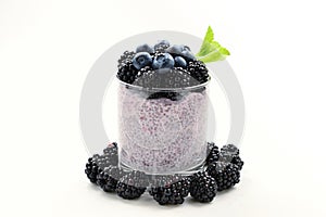 Chia pudding with mint, blueberry, blackberry on a white background. Space for text or design