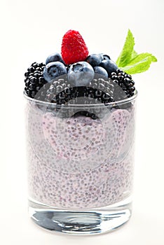 Chia pudding with mint, blueberry, blackberry on a white background. Space for text or design