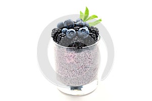 Chia pudding with mint, blueberry, blackberry on a white background. Space for text or design