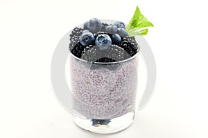 Chia pudding with mint, blueberry, blackberry on a white background. Space for text or design