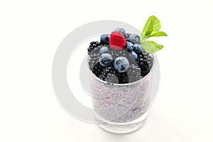 Chia pudding with mint, blueberry, blackberry on a white background. Space for text or design