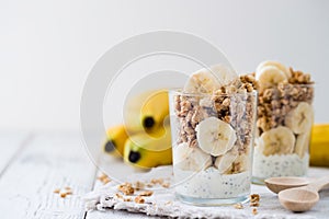 Chia pudding parfait, layered yogurt with banana, granola. Copy space