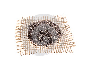 Chia Seed. Grains over hessian fabric, isolated white background