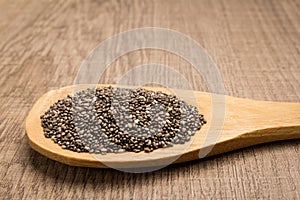 Chia Seed. Grains in wooden spoon. Rustic.