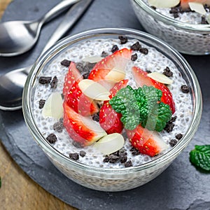 Chia seed pudding with strawberries, almond and chocolate cookie crumbs, square format