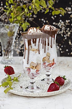 Chia seed pudding with strawberry and biscuits in a glass