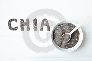 Chia seeds. Chia word made from chia seeds with spoon full of chia in a bowl.