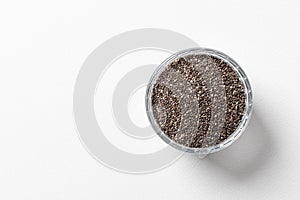 Chia seeds in a cup beautifully laid out on a white background. Top view. copy space.. Vegetarian food