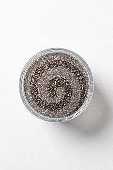 Chia seeds in a cup beautifully laid out on a white background. Top view. Vegetarian food