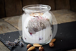 Chia seeds, delicious meal made with chia seeds, berry fruit, hazelnut, almond and yougurt - dairy