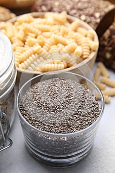 Chia seeds and different gluten free products on white table